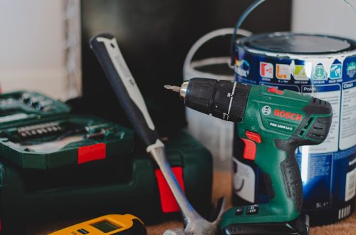 red and black cordless power drill beside black and red cordless power drill