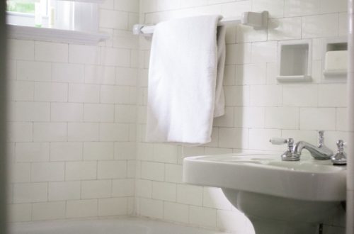 white towel on white ceramic bathtub