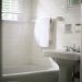 white towel on white ceramic bathtub