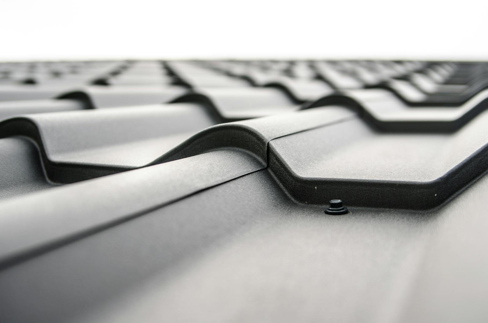 Close-up view of a metal roof's wavy design showcasing rivets and structural detail.